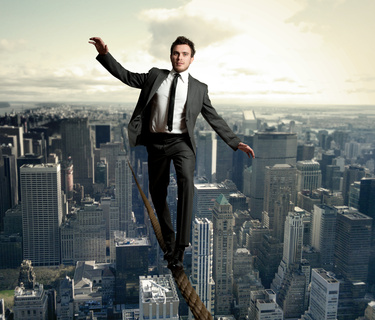 Equilibrist businessman Businessman is balancing on a rope